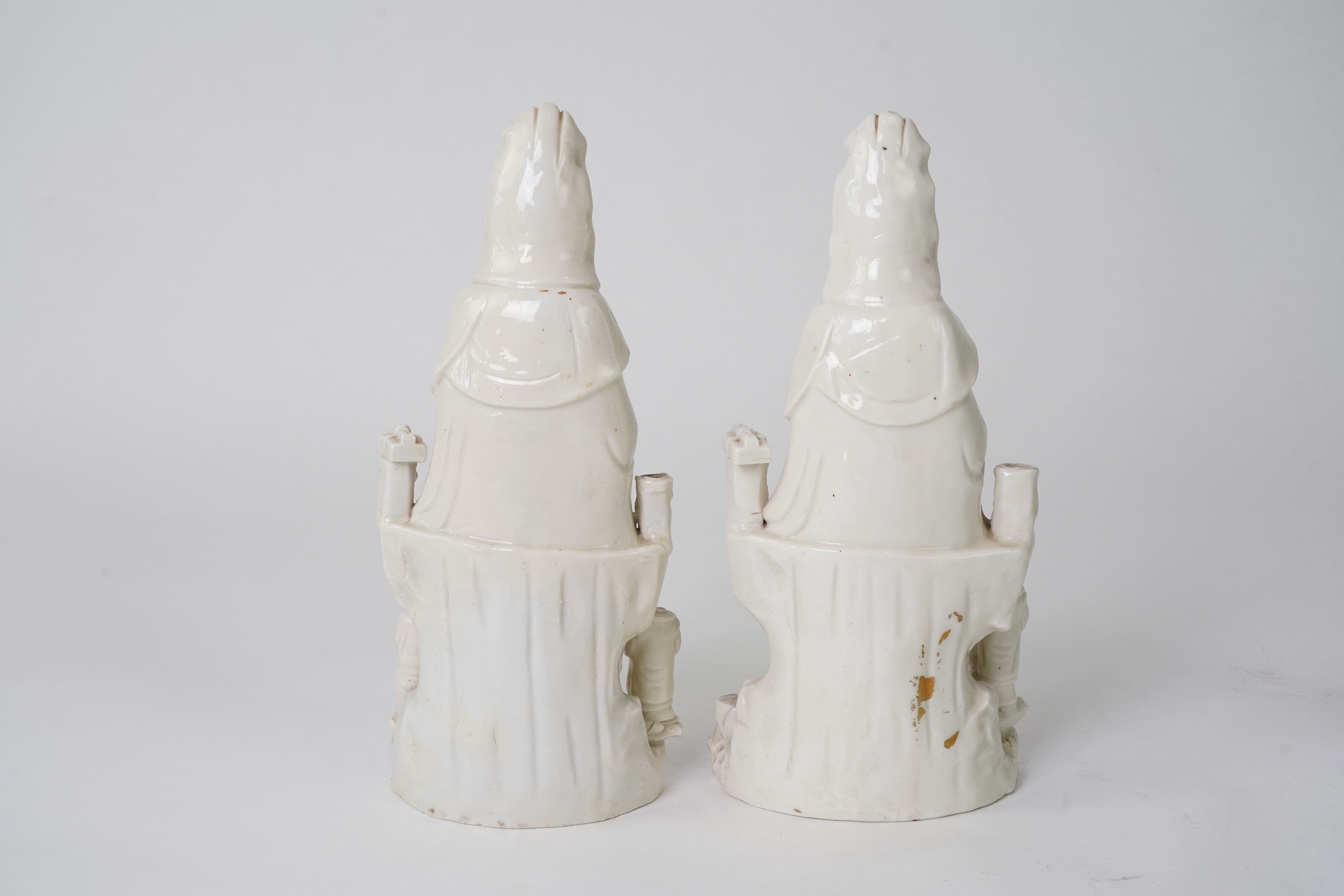 A pair of Chinese blanc de chine groups of Guanyin and children, 18th century